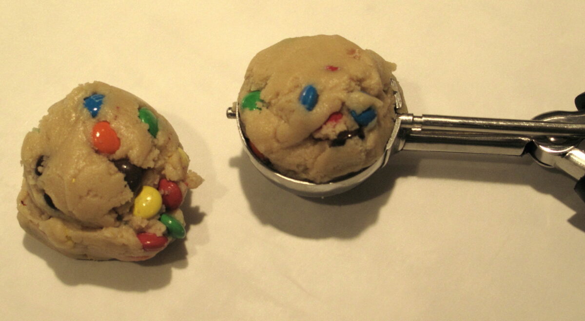 M&M Mega Cookies dough in cookie scoop.