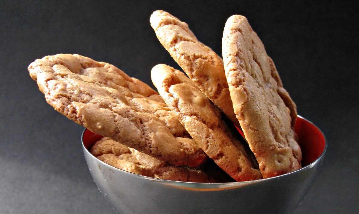 Honey-Roasted Peanut Cookies in a bowl showing thin, crisp edge.