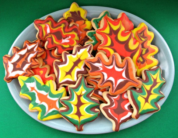 Decorated Thanksgiving Sugar Cookies on a platter with a green background.