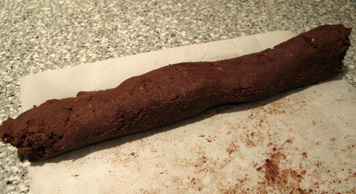 Roll dough into a log the length of the parchment paper.