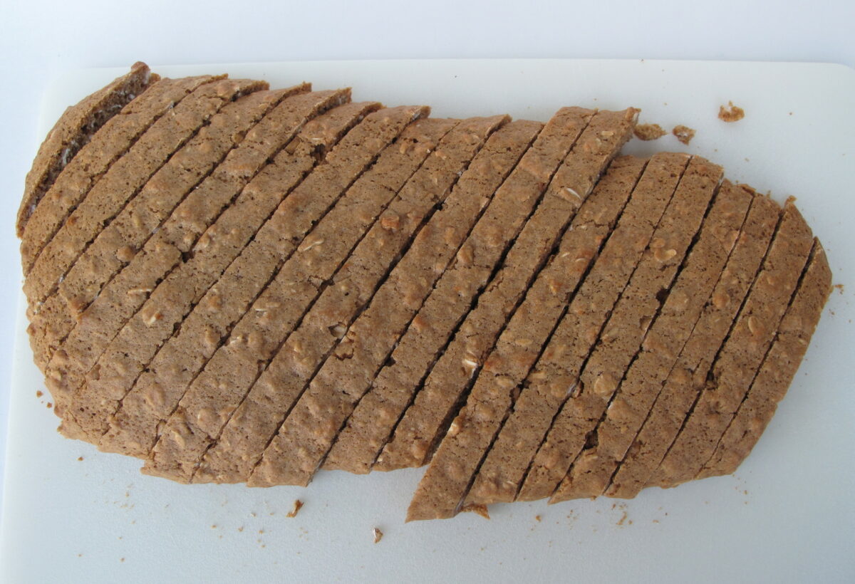 Overhead image of baked biscotti log sliced diagonally.