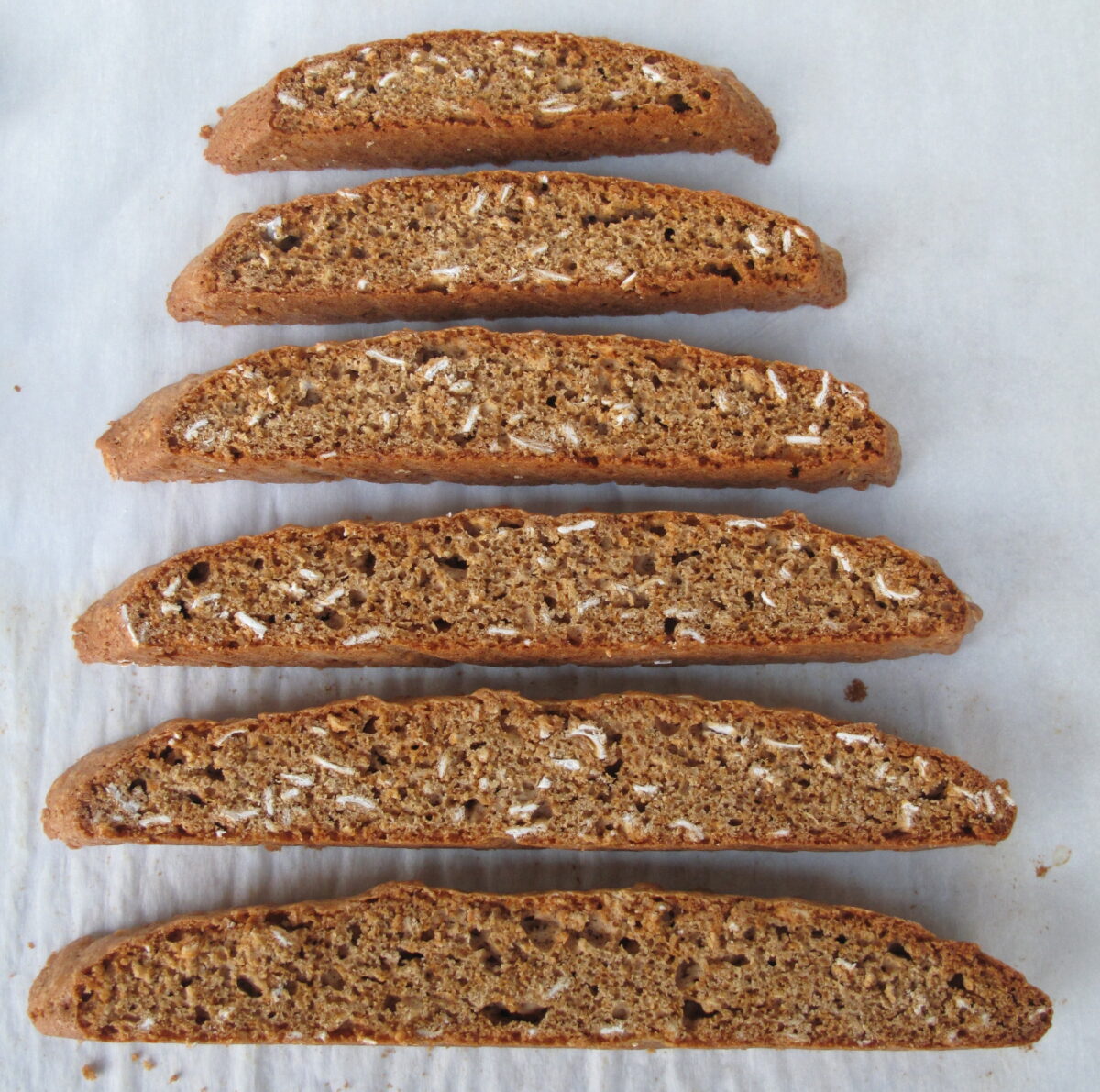 Biscotti lying with cut side up to show oats inside.