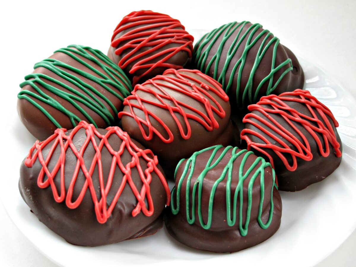 Chocolate Marshmallow (Mallomar) Cookies are coated in chocolate and have decorative red or green zigzags.