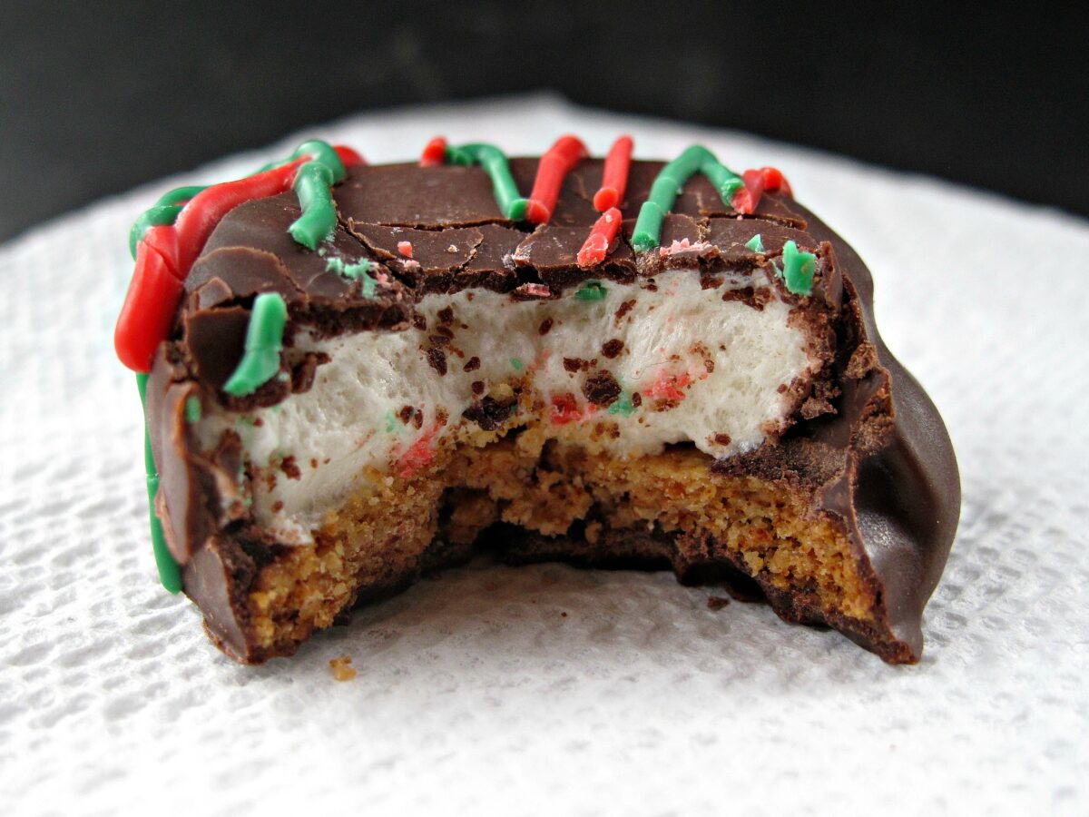 Cookie with a bite showing inside marshmallow topped graham.