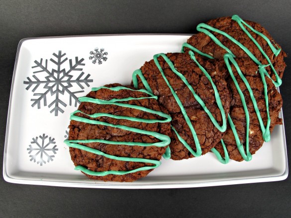 Cookies with green zigzags on top on a white serving tray.