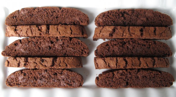 Biscotti lined up on a white plate.