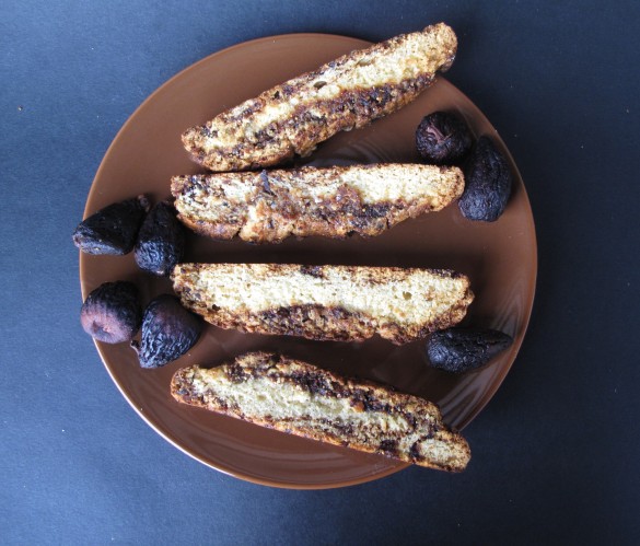 Fig Jam Biscotti on a brown plate with dried figs.