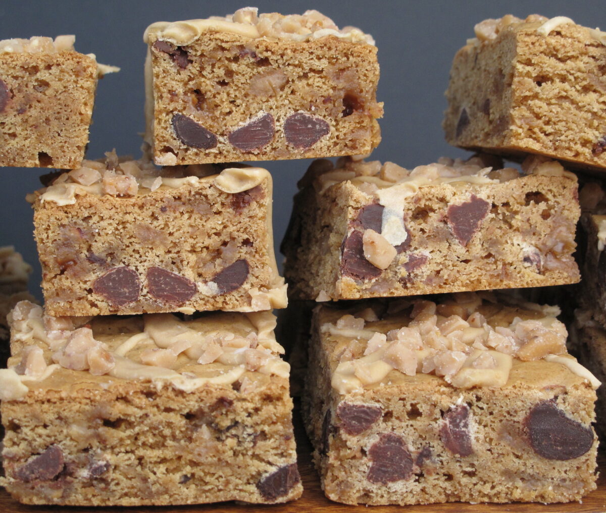 Stack of Biscoff Toffee Crunch Bars showing cut edges and chocolate and toffee bits inside.