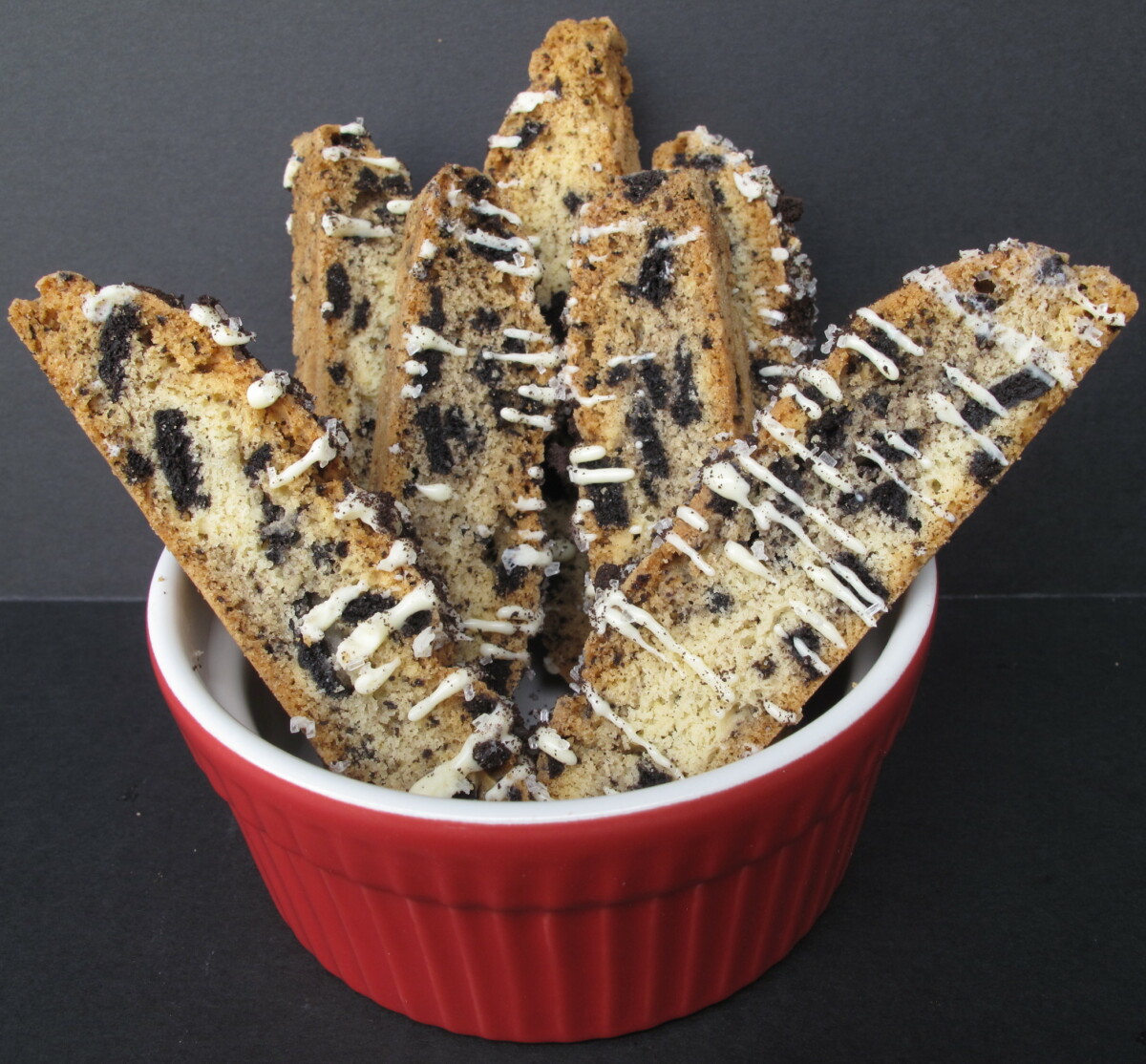 Oreo Biscotti standing in a red bowl.