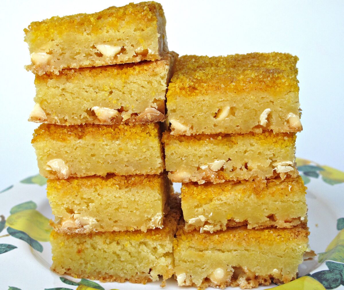 Two stacks of Lemon Bars  white chocolate chips in a chewy, citrus bar. 