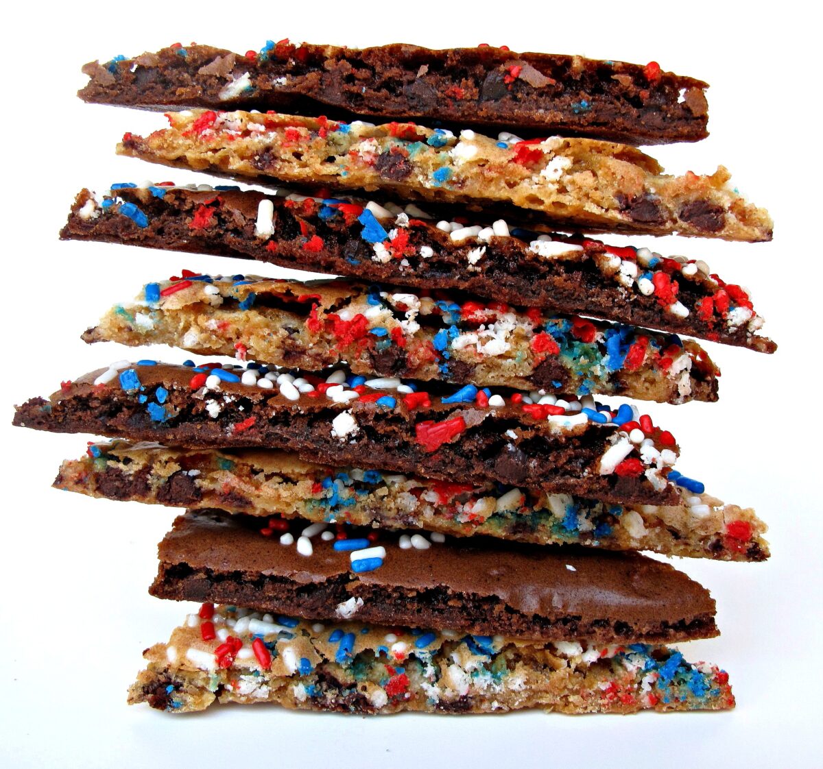 A stack of brownie and cookie brittle showing the thin, crispy cut edges.