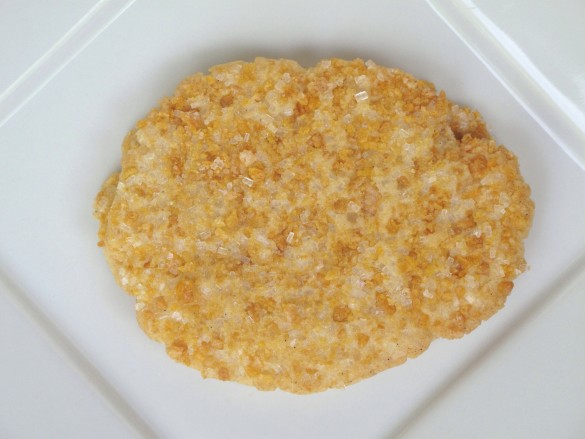Frosted Flakes Sugar Cookie on a white plate coated in sugar and bits of cereal