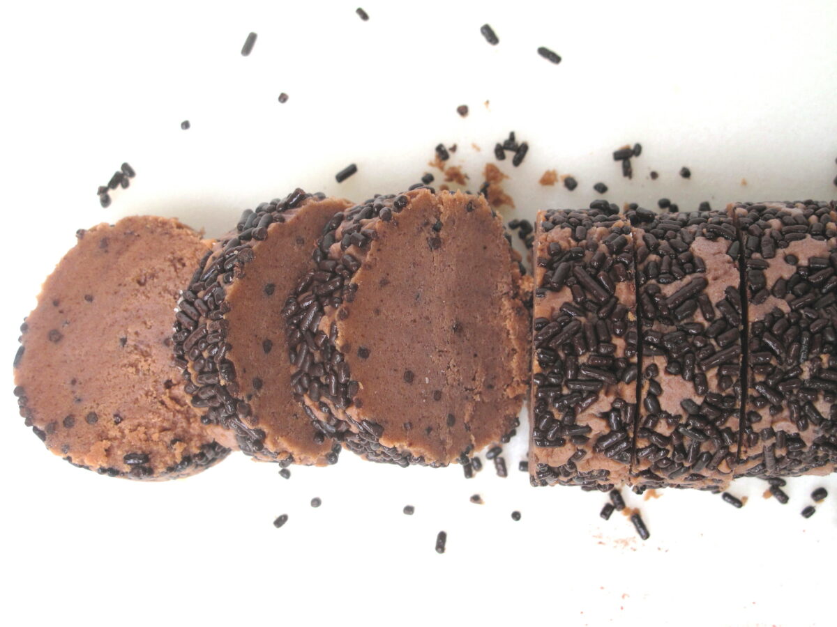 Sliced chocolate dough log with sprinkles.