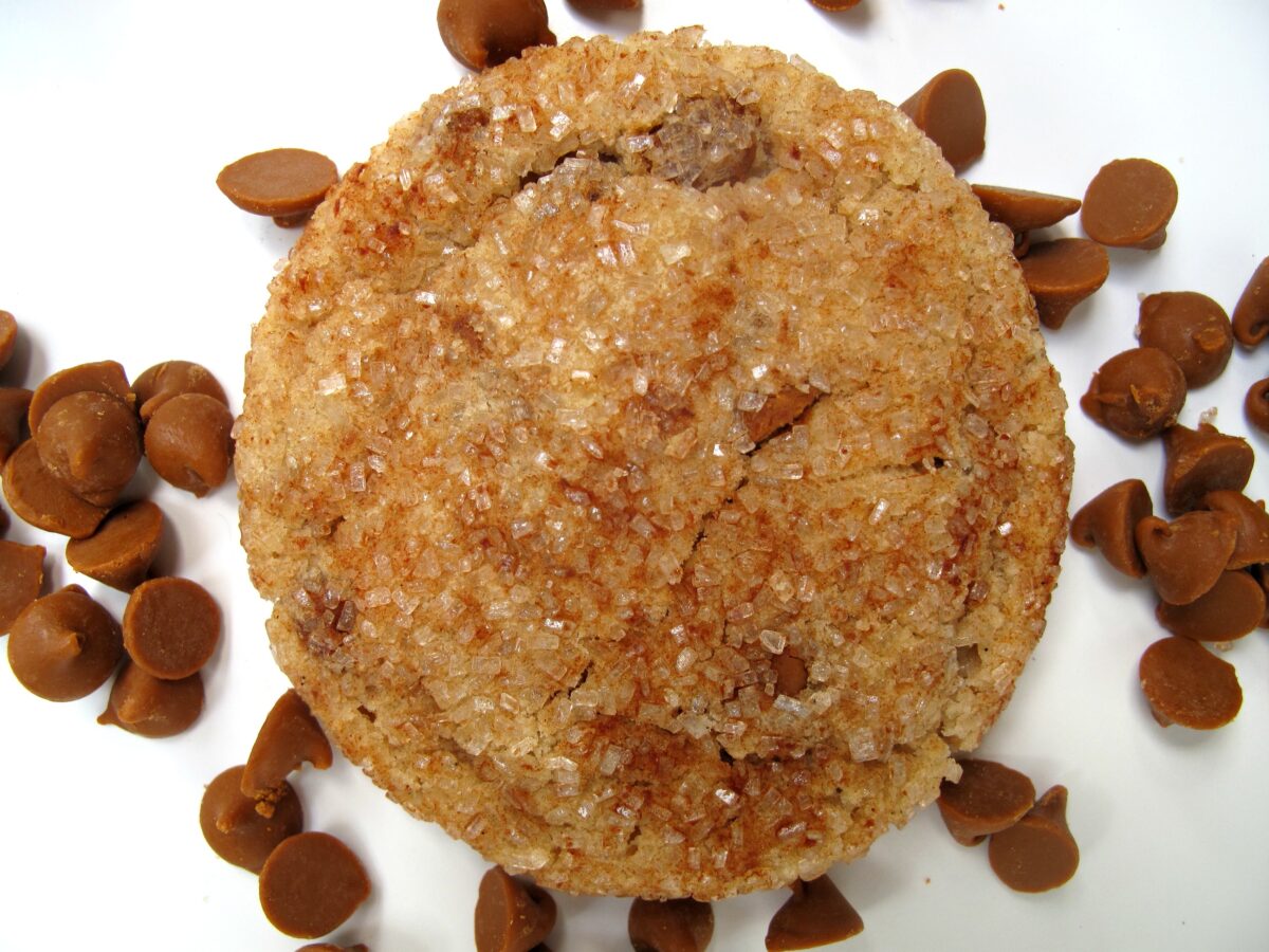 Overhead closeup of sugar coated cookie with cinnamon baking chips.