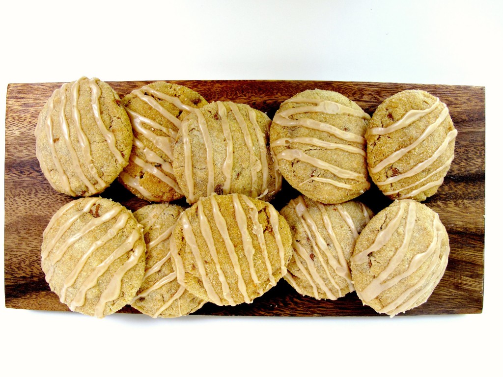 Cinnamon Dream Cookies with striped icing on a wooden platter