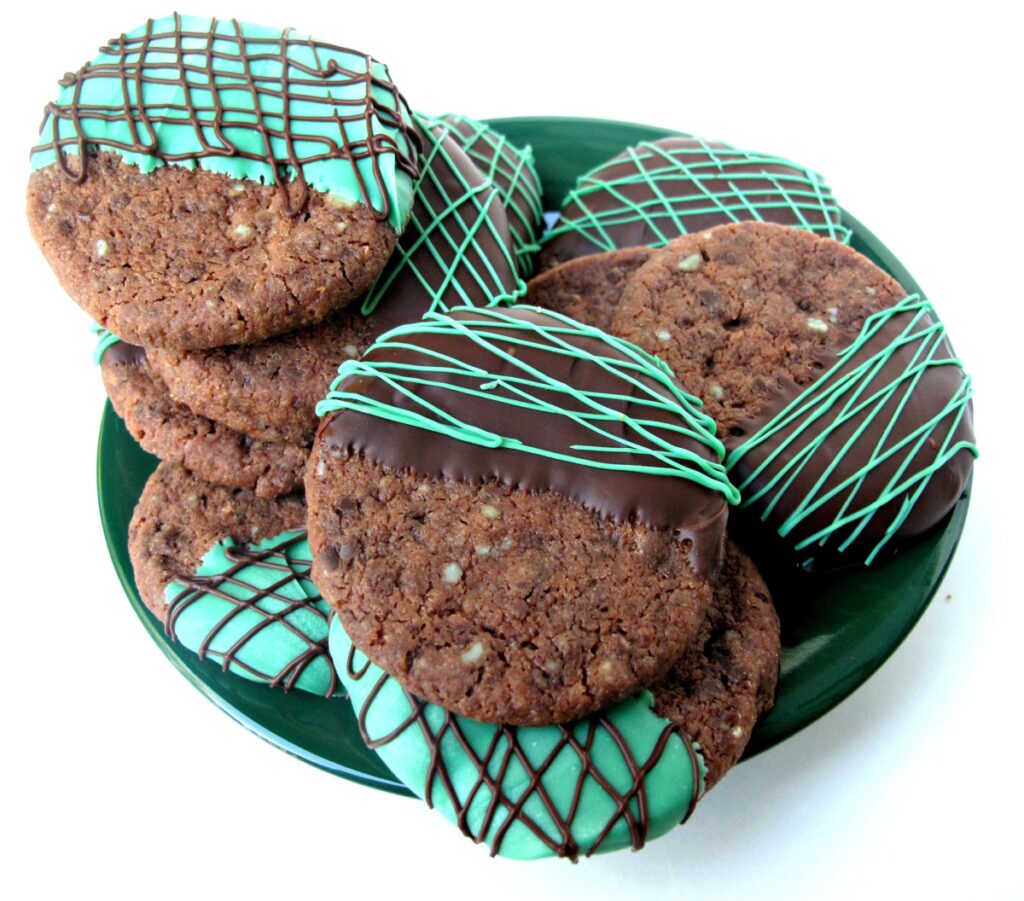 Chocolate Peppermint Shortbread Cookies with chocolate dough speckled with chopped mint candy, half dipped in chocolate.