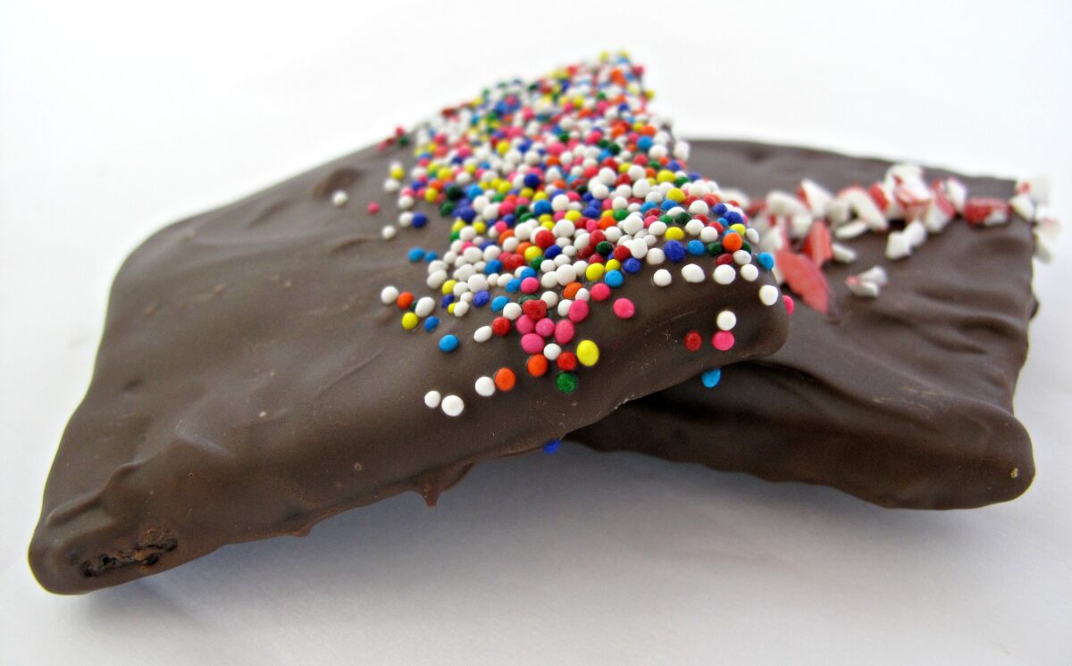 Closeup of two Chocolate Covered Graham Crackers showing chocolate coated top and edges.