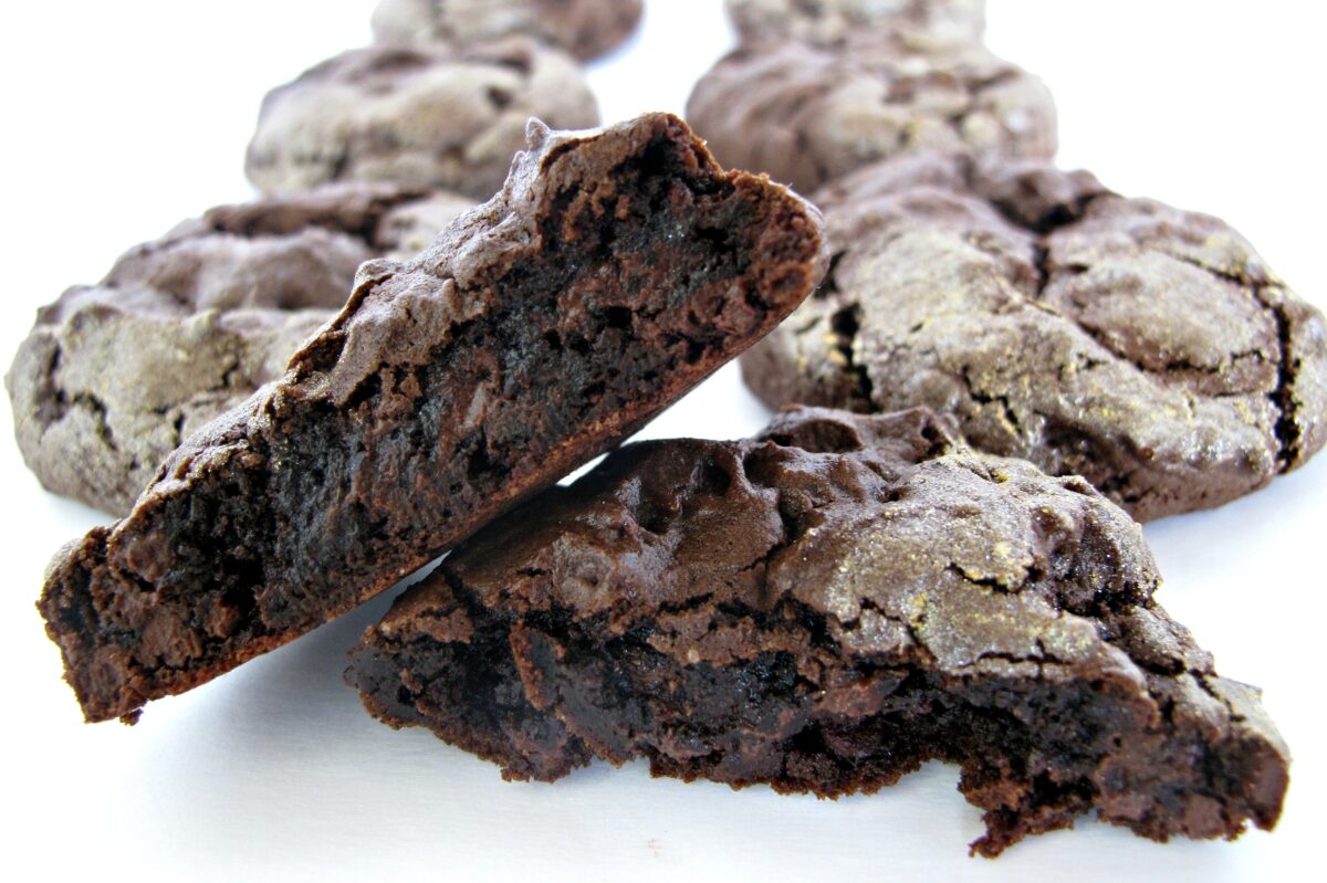 Closeup of a cookie cut in half to show the ultra chocolaty, fudgy interior.