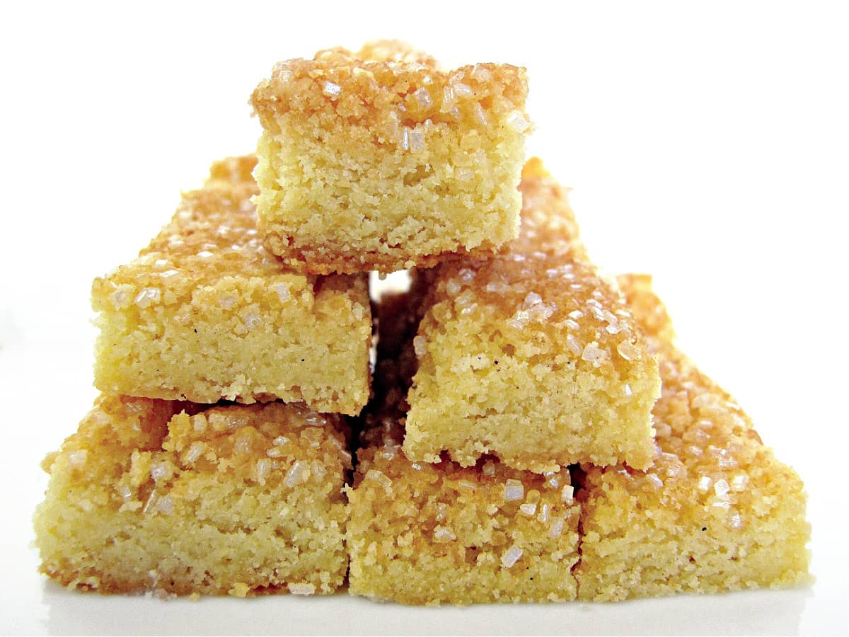 Stack of shortbread each topped with sparkling sugar.