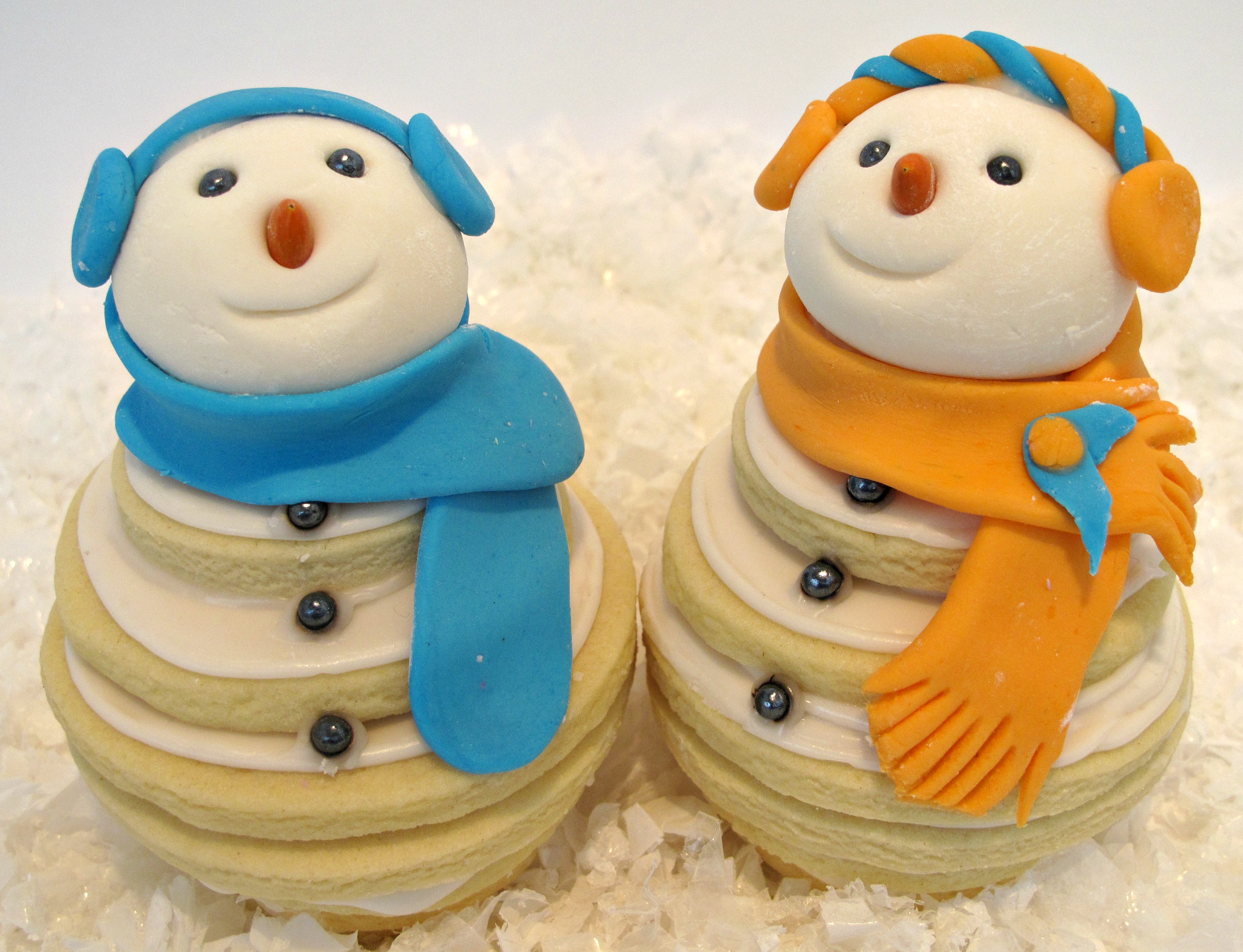 Closeup of two sugar cookie snowmen.