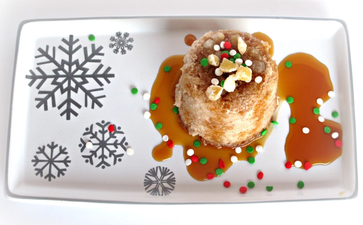 Gingerbread Mug Cake turned out onto a platter with ginger and caramel syrup.