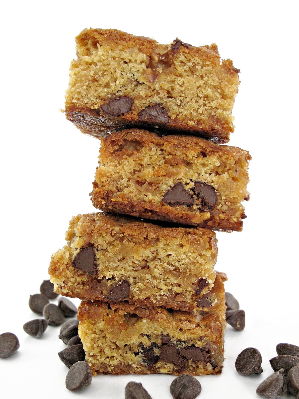 Stack of thick cookie bars with chocolate chips inside.