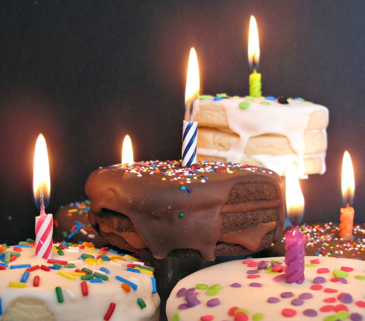 Closeup of lit candles on top of cookies.