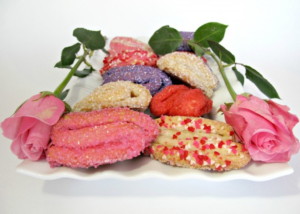Rose Bud Butter Cookies on a platter with two pink roses.