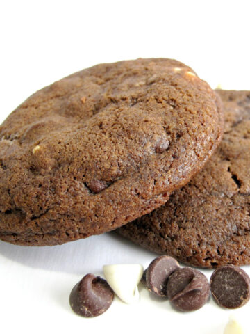 Closeup of two chocolate cookies with chocolate chips.