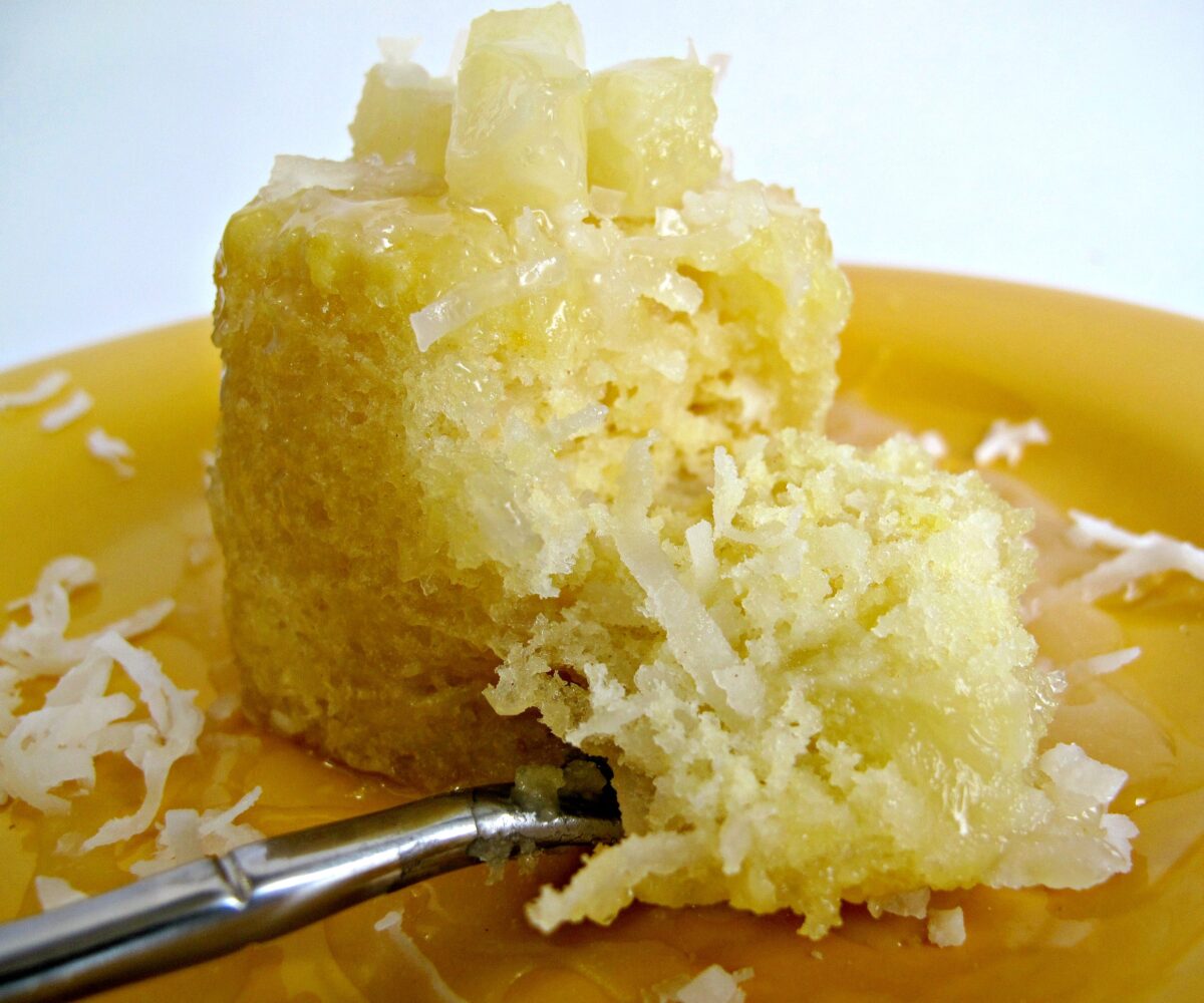Piña Colada Cake with a fork full of cake in the front.