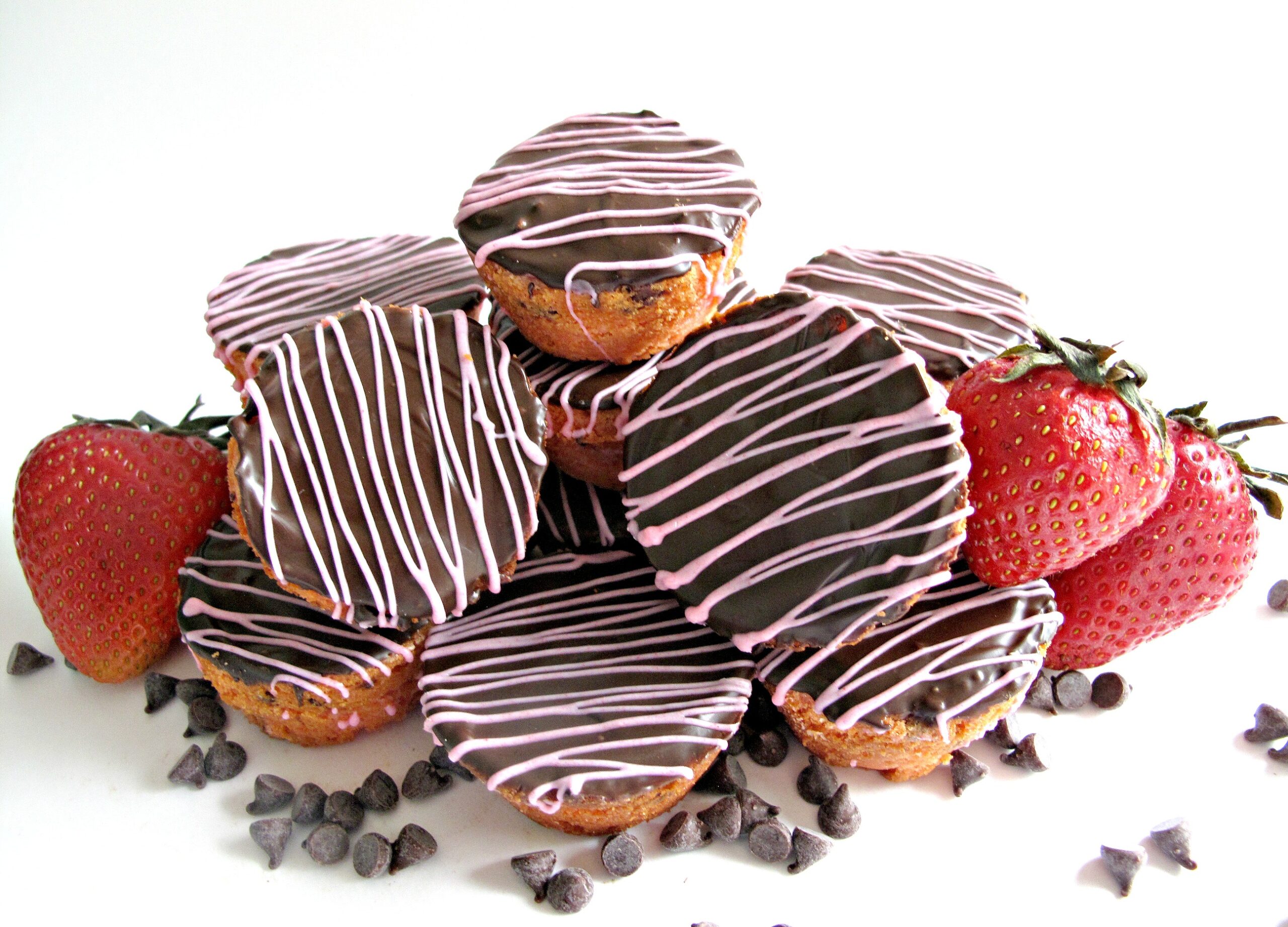  Blondie Bites in a pile with mini chocolate chips and strawberries. 