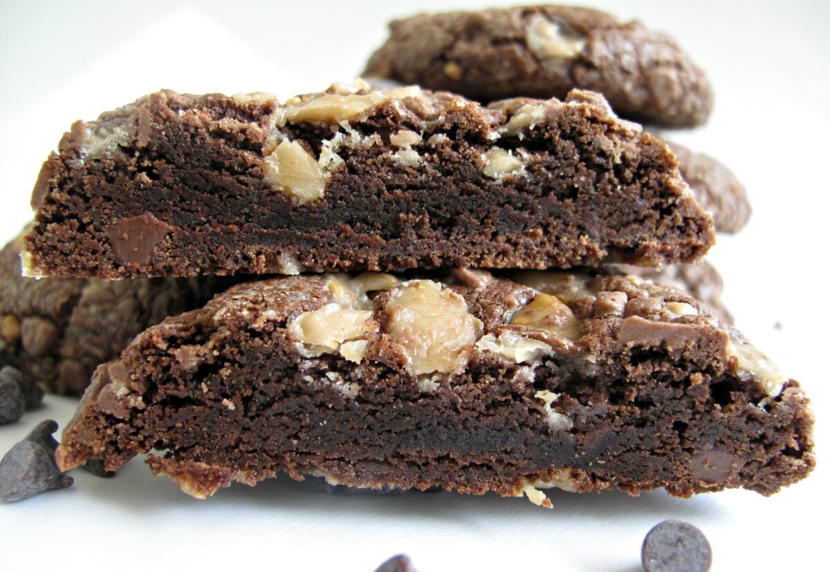 A cookie cut in half to show the soft, fudgy inside.