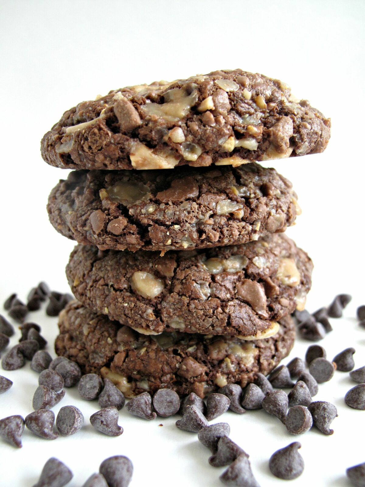 Stack of cookies surrounded by chocolate chips.