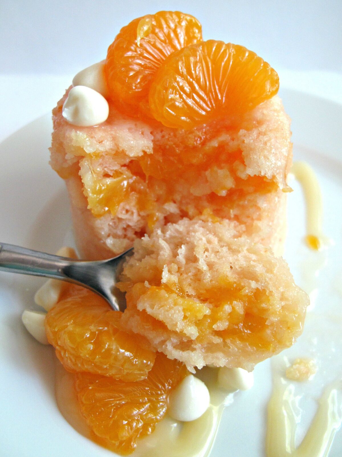 Inside and spoonful of  Mandarin Orange Microwave Mug Cake.