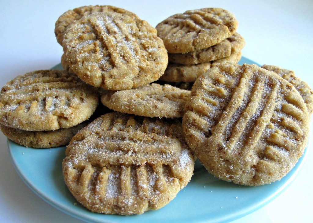 Cinnamon Divinity Cookies on a blue plate each with a criss cross design on top made with the prongs of a fork