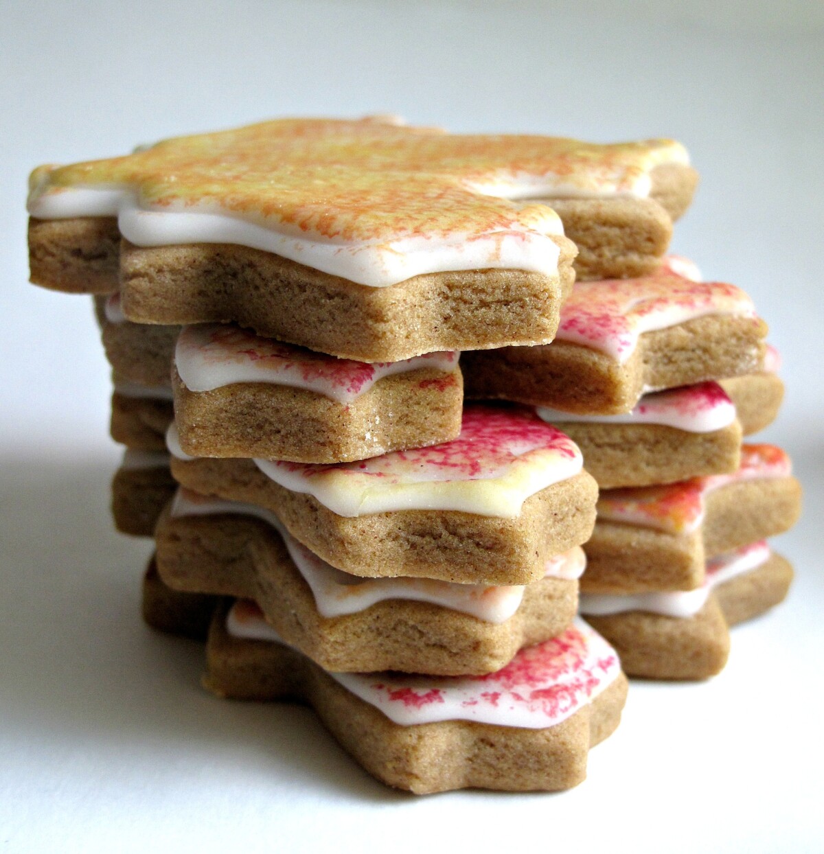 Stack of decorated cutout gingerbread leaves.