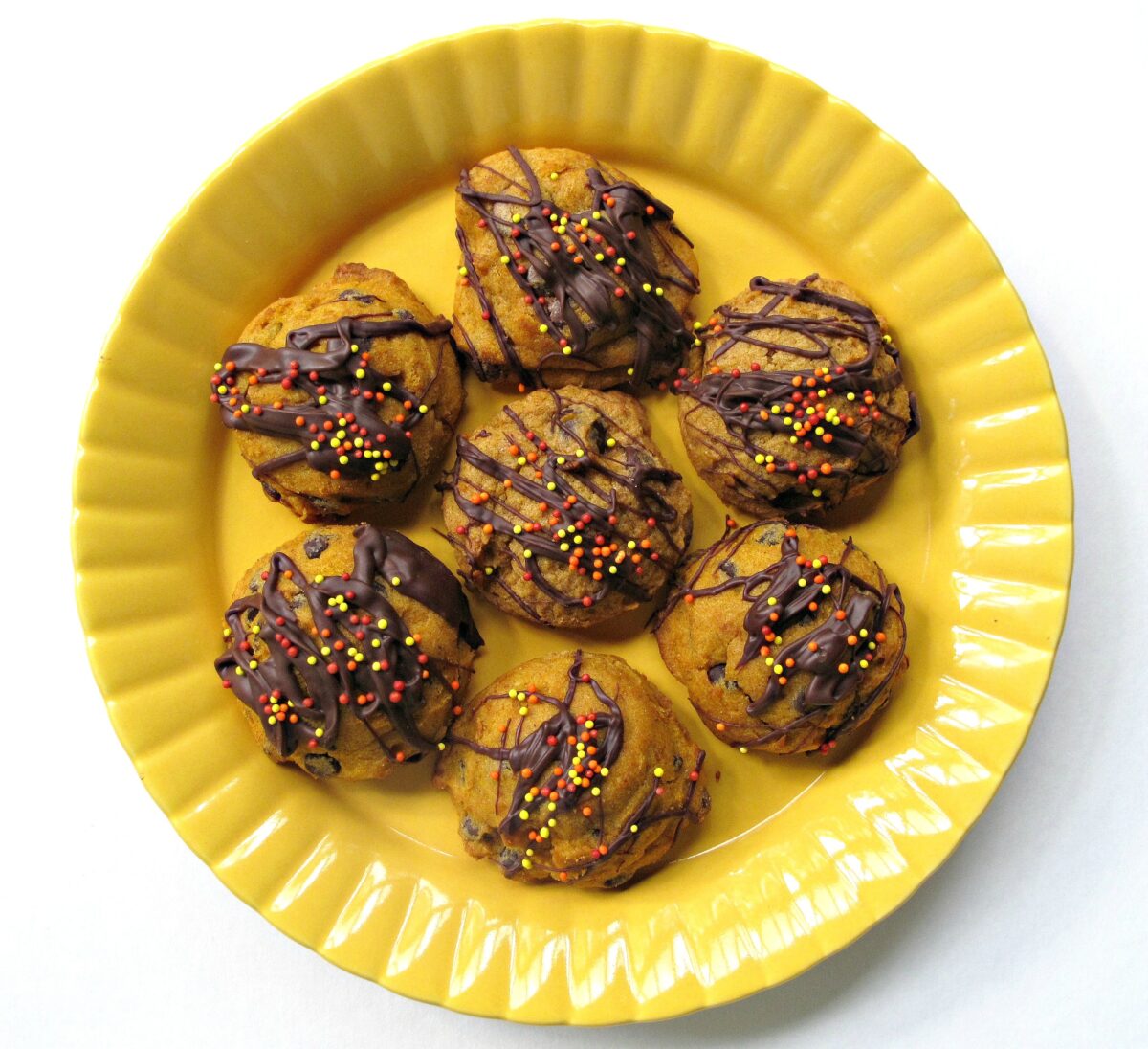 Chocolate drizzled  on a yellow plate.