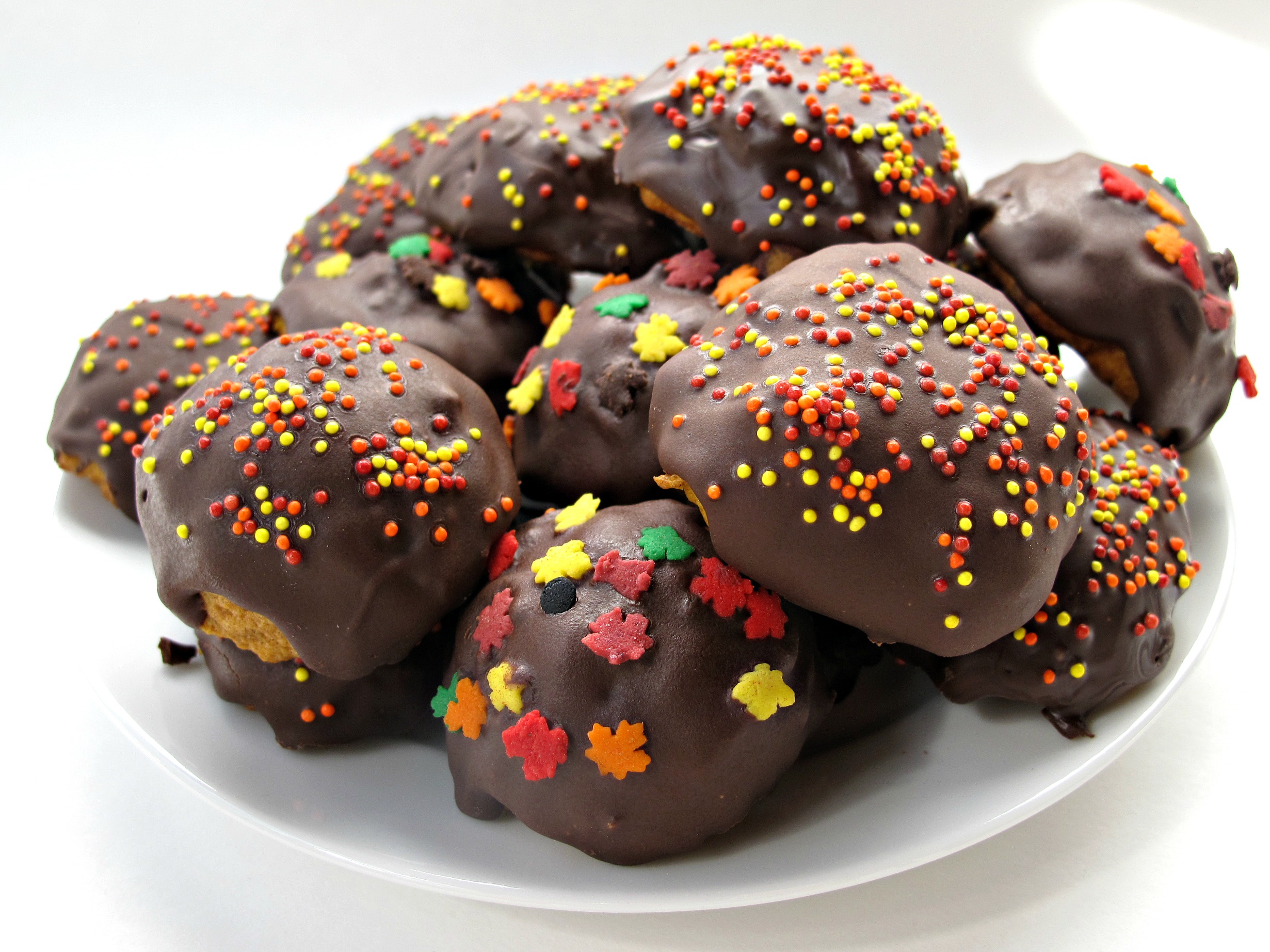 Round Pumpkin Chocolate Chip  Cookies  coated in chocolate with fall sprinkles.