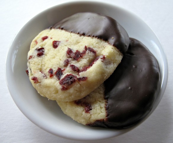 Two Cranberry Orange shortbread cookies in a small bowl