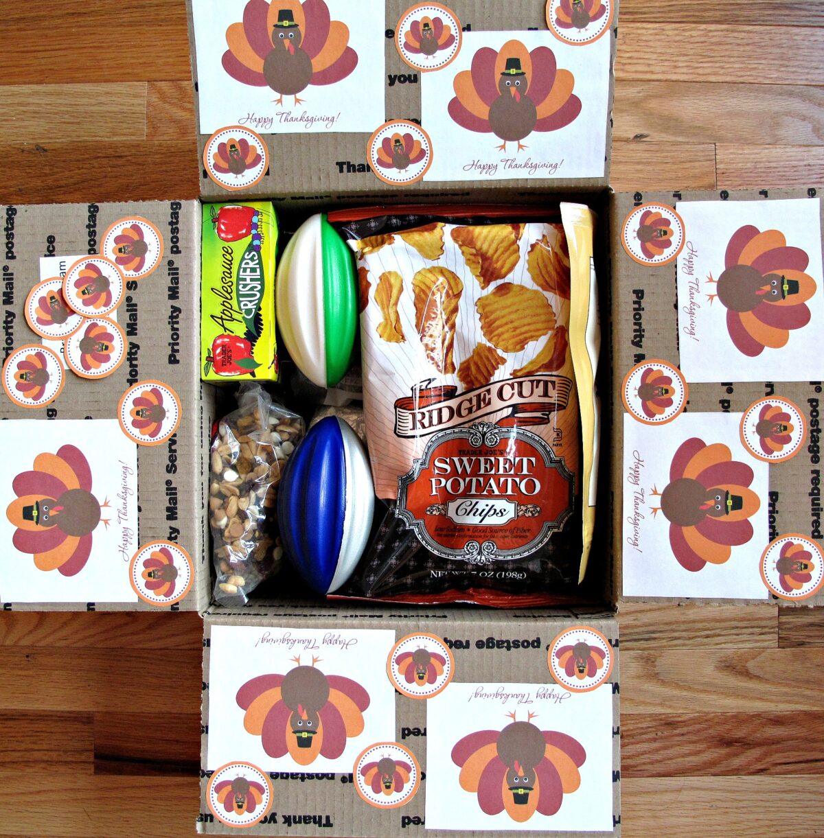 Thanksgiving Military Care Package decorated with turkey illustrations and filled with snacks.