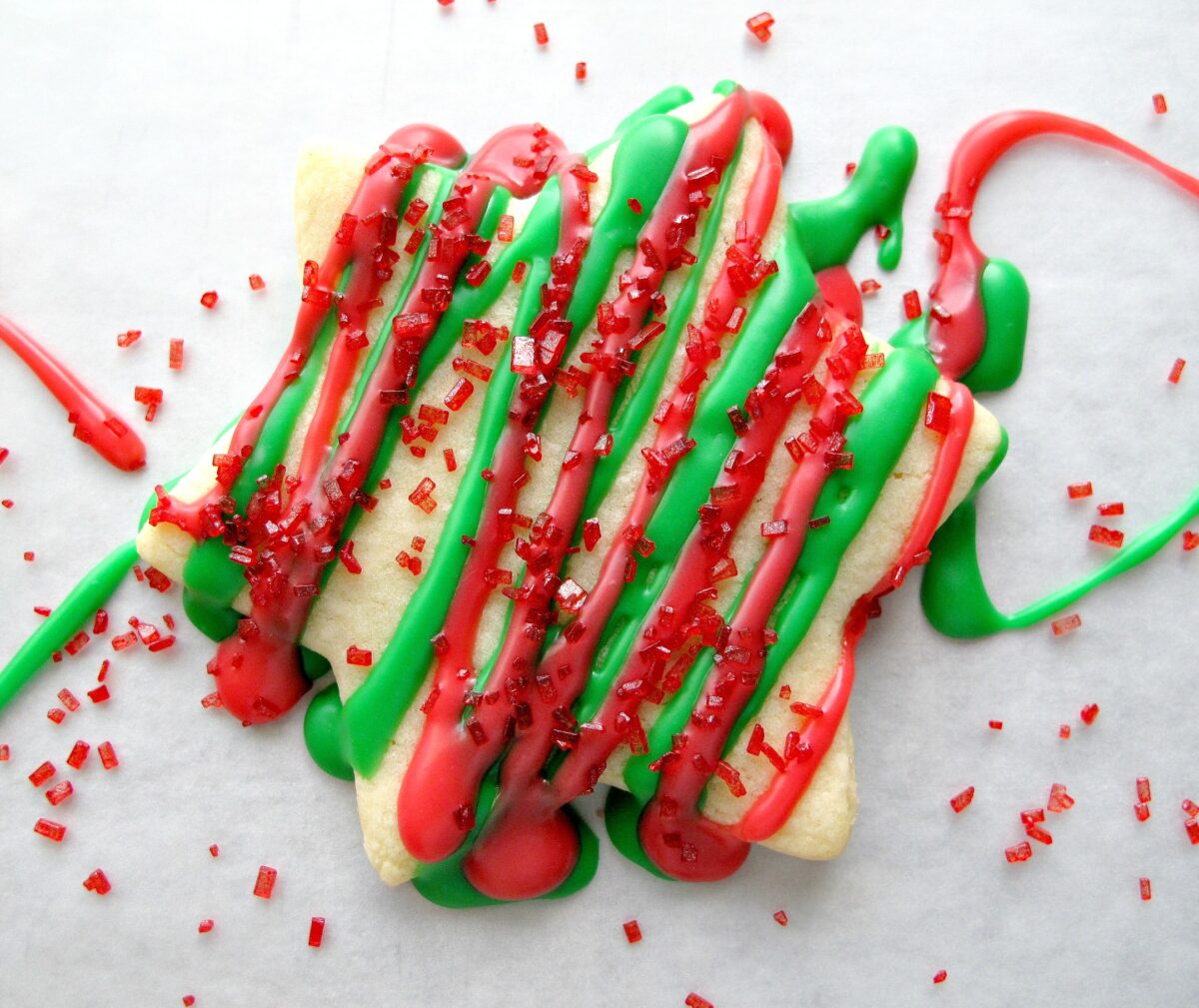 Closeup of red and green icing on a cookie.