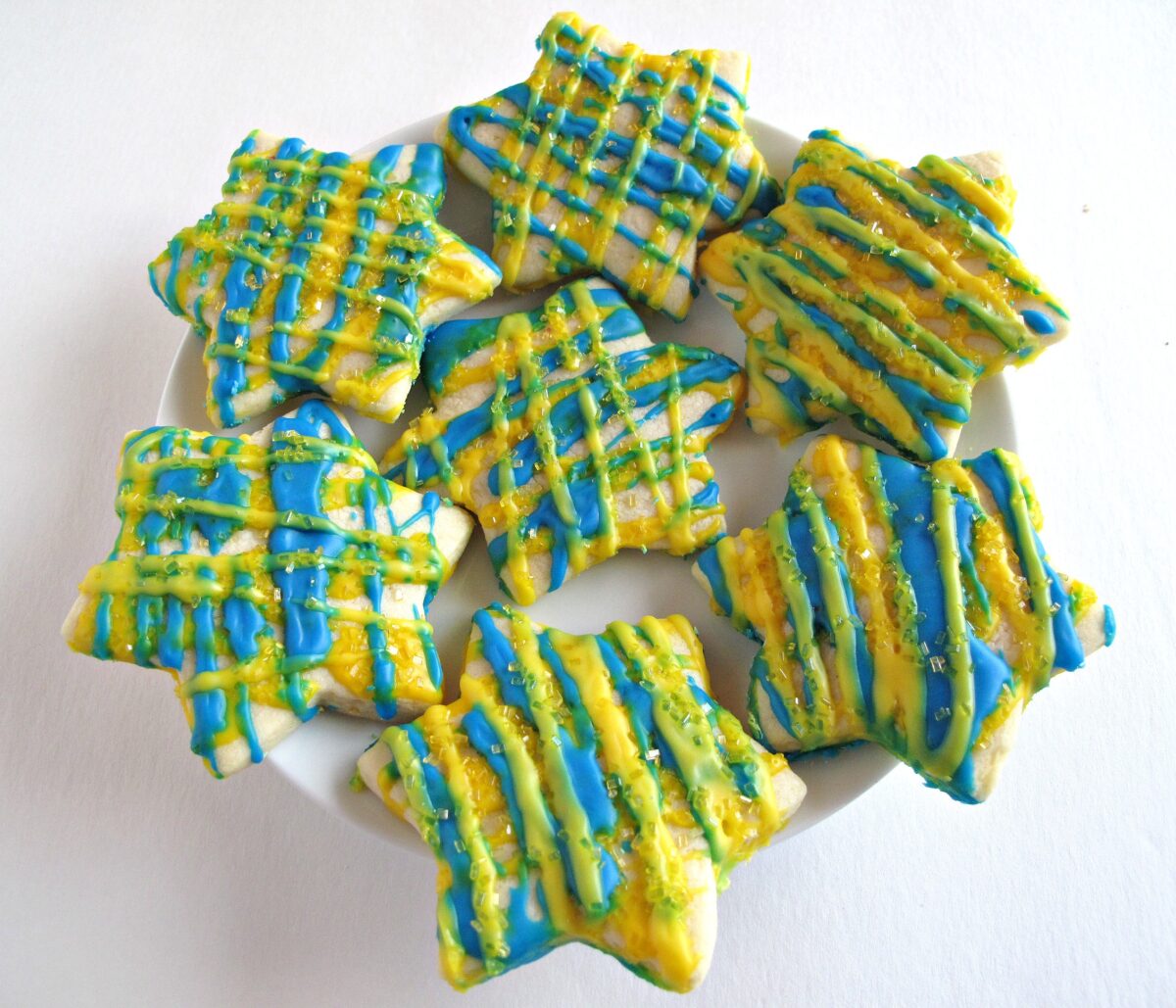 Star cut-out cookies with yellow and blue zigzag icing.