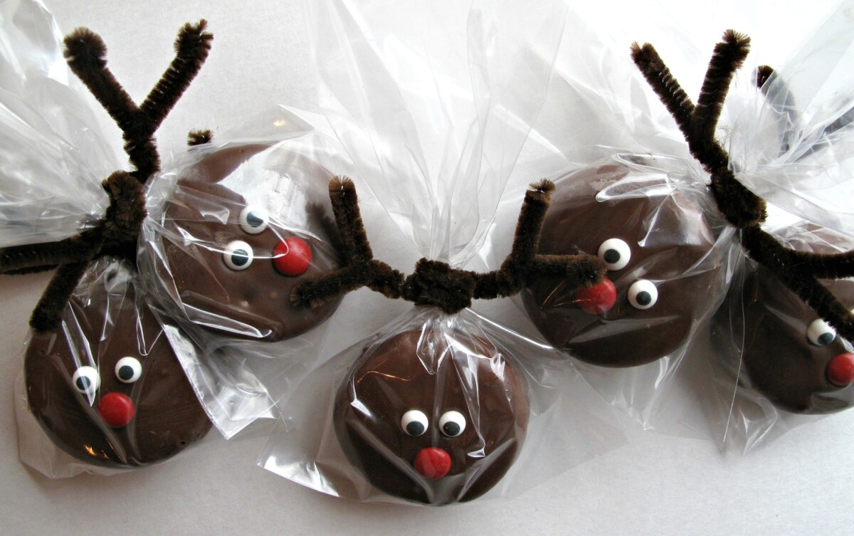 Rudolph chocolate covered oreos in cellophane bags, pipe cleaner antlers, candy eyes, and red candy nose.