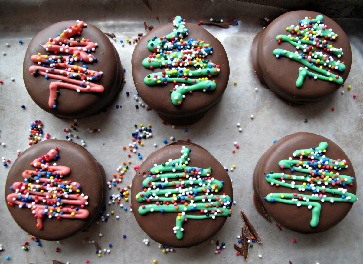 Six Chocolate Covered Oreos with a Christmas tree design in red and green.