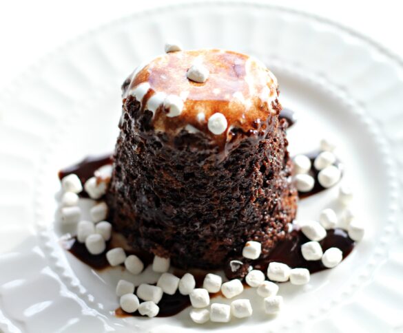  Hot Chocolate Mug Cake on white plate sprinkled with mini marshmallows