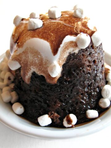 Choclate mug cake topped with marshmallow creme and mini marshmallows.