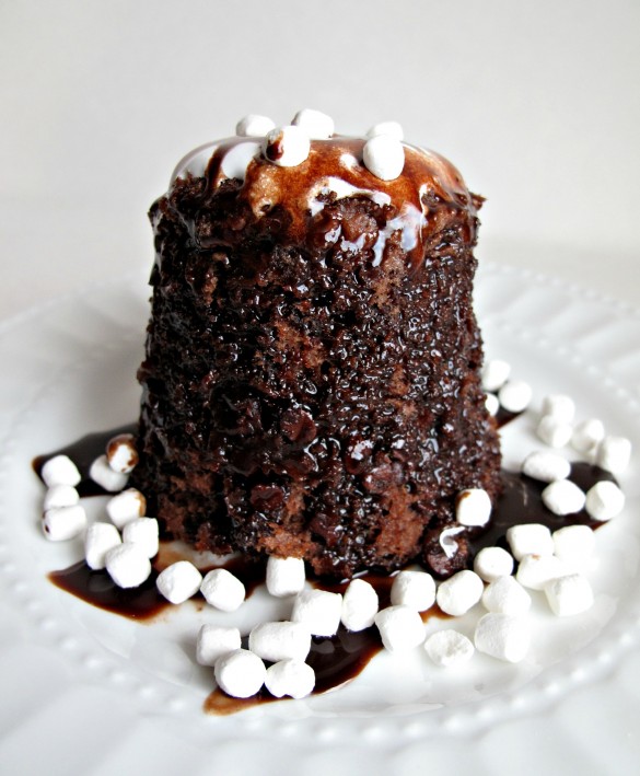 Hot Chocolate Mug Cake on white plate surrounded by mini marshmallows