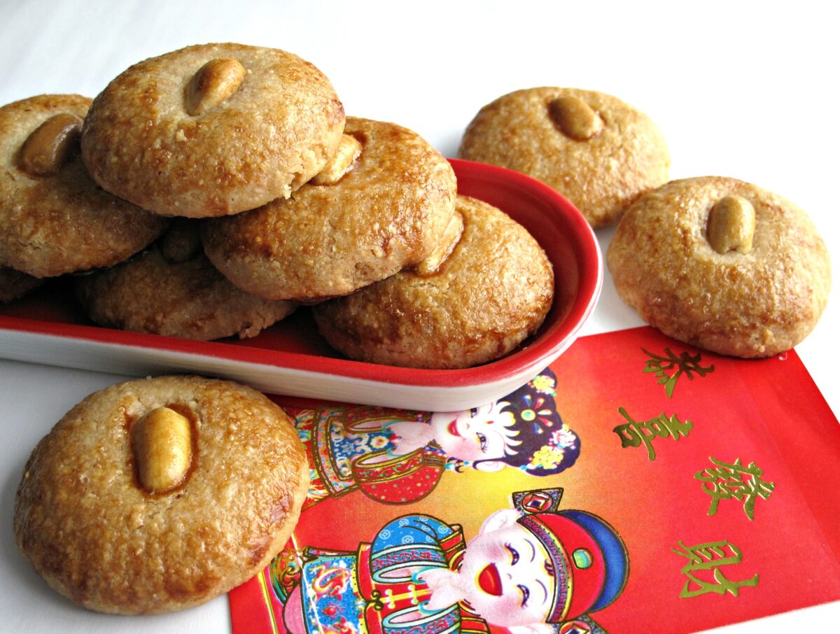 Peanut topped cookies with a Chinese New Year red money envelope. 