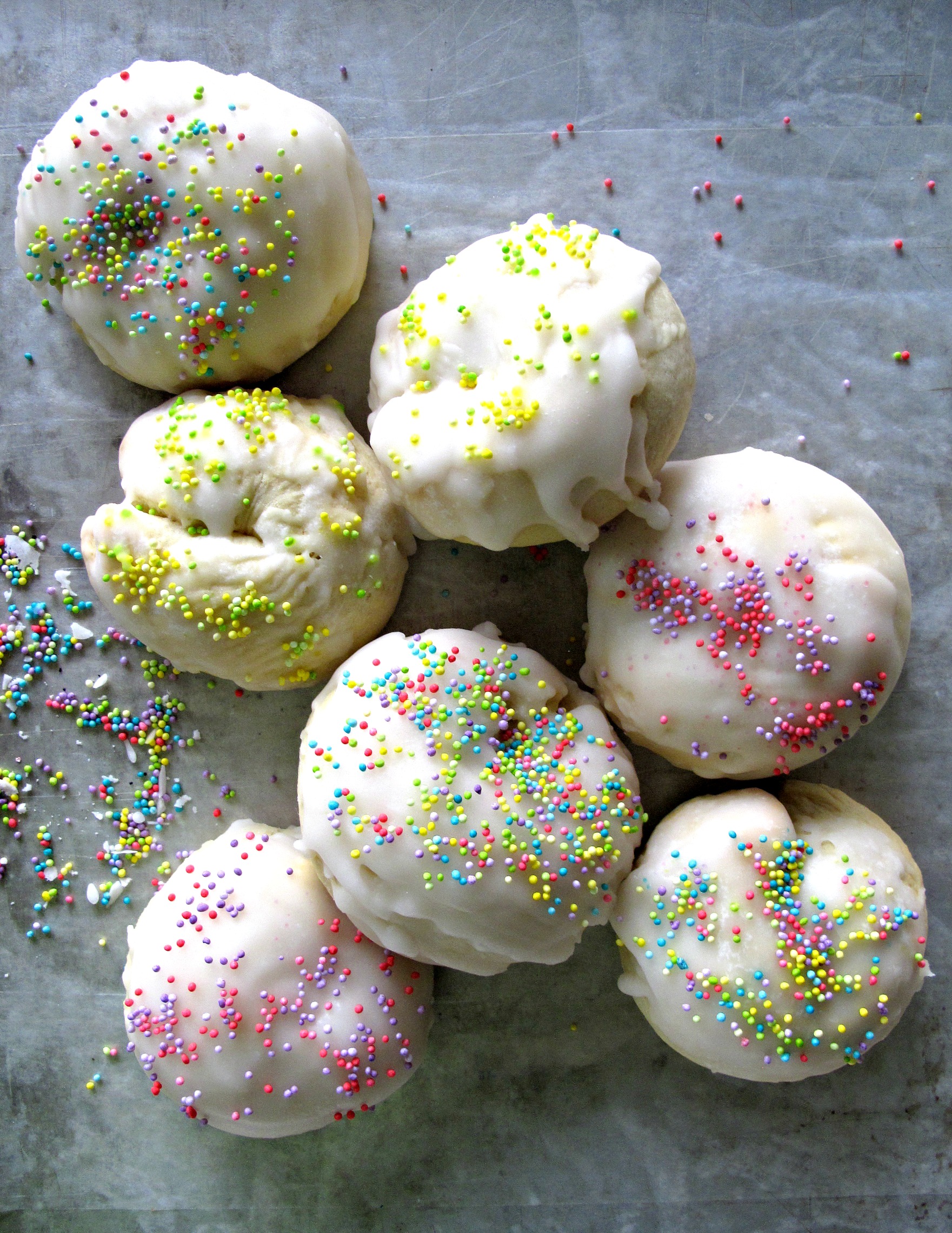 Italian Easter Cookies (Taralli Dolce Di Pasqua), puffy, ball shaped and iced with pastel nonpareil sprinkles.