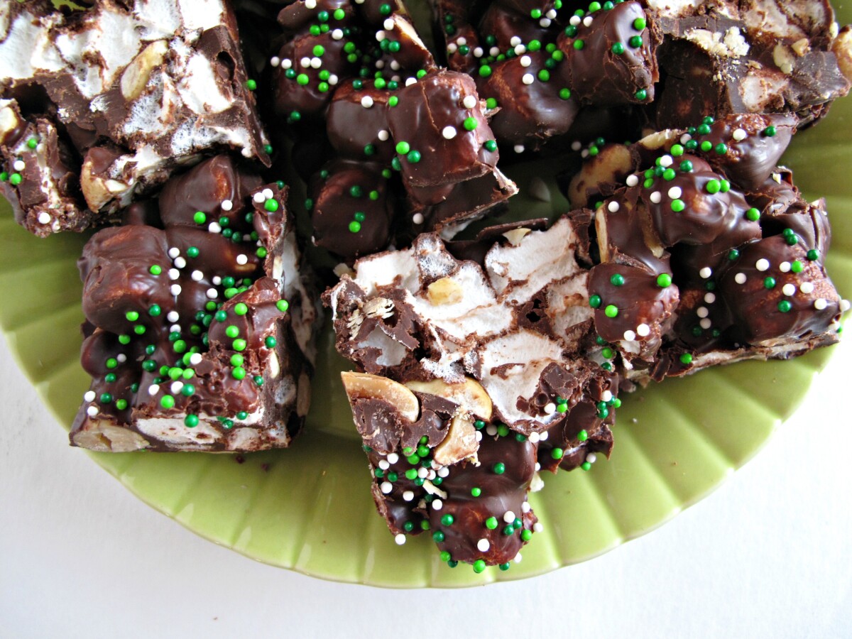 Close up of shiny chocolate top with rainbow chip sprinkles.